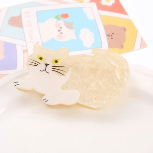 Cute white marble pattern cat shaped hair claw clip displayed on a minimalist plate