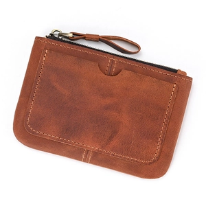 Detailed close-up of brown crazy horse leather coin purse with front card slot and zipper