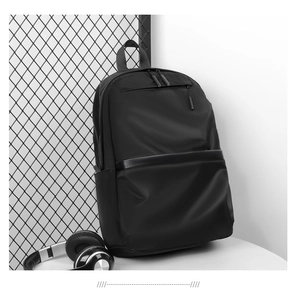 Detail view of water-resistant black nylon backpack with a main compartment and front pocket