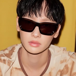 Fashionable oversized square sunglasses with dark lenses on a male model with yellow background