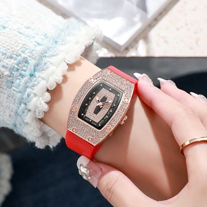 Tonneau-shaped rose gold watch for women with red silicone strap and crystal-set dial