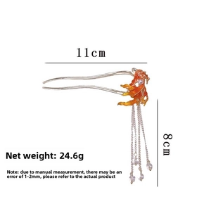 Detail of Chinese style U-shaped hair stick featuring an orange carp and long tassels