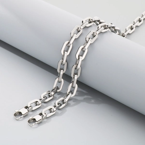 Detailed macro view of 7mm silver stainless steel square link chain with lobster clasps
