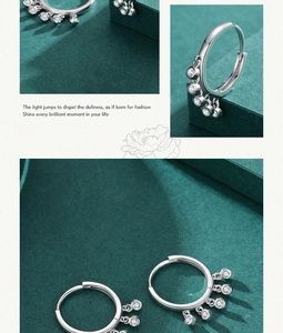 Macro shot of S925 sterling silver hoop earrings with five sparkling pavé charms