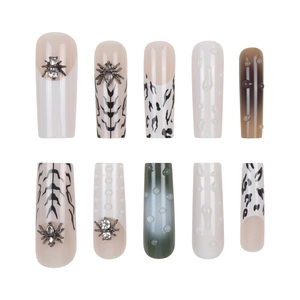 Detail of 3D Halloween press on nails with metal spider charms and gothic zebra patterns
