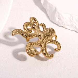 Artistic octopus ring in 18k gold finish with detailed tentacles on white stone base