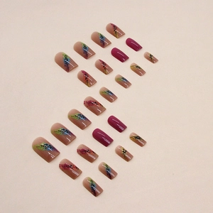 Medium square press-on nails with colorful abstract spray patterns and nude pink base