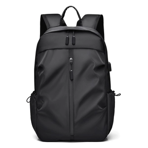 Modern black minimalist backpack with USB charging port and vertical front zipper