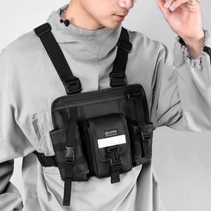 Detail of multi-functional black tactical chest bag with adjustable straps and buckles