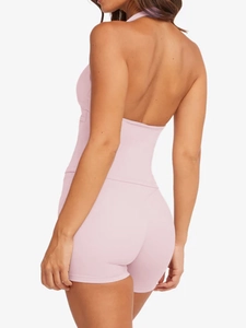 Detail view of the pink backless yoga set showing slim fit and strappy back design