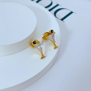 Detail of cocktail glass earrings with gold finish and inlaid triangular zircon crystals