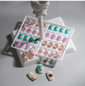 3D resin cartoon bear and cat nail charms with floral accents and white display stand