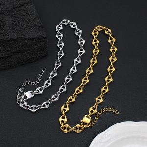 18K gold and silver stainless steel anchor link necklace set on black rock