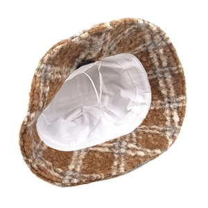 Detail of checkered teddy fleece bucket hat showing adjustable inner drawstring and lining