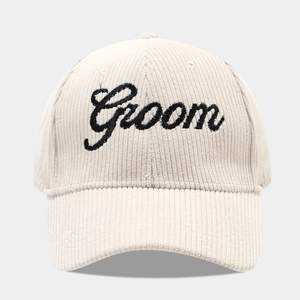 Close-up of Groom embroidery on beige corduroy baseball cap with soft texture