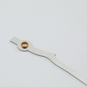 Precision silver clock hand with gold mounting hole on a neutral background