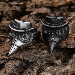 Gothic plague doctor mask rings in polished chrome and vintage silver on tree bark