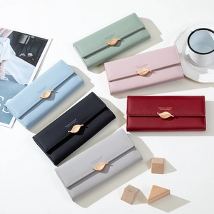 Flat lay of multiple retro matte leather long wallets featuring leaf metal buckles