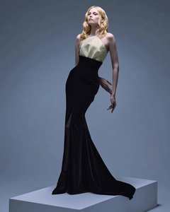 Détail du bustier en satin doré et robe sirène en velours noir avec fente à la taille haute