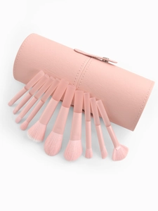 Close-up of peach pink makeup brush set with matching cylindrical PU leather travel case