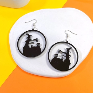 Detail of Halloween witch silhouette earrings made of black acrylic on a vibrant tricolor base