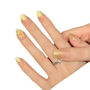 Almond shaped press-on nails with pink base, cat-eye shimmer, and 3D floral accents
