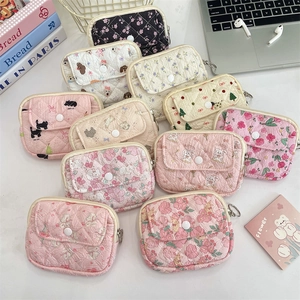 Detailed view of quilted cotton organizer bags with floral and animal patterns