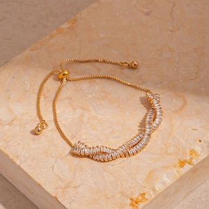 Detail of adjustable gold bracelet featuring double rows of baguette cubic zirconia stones