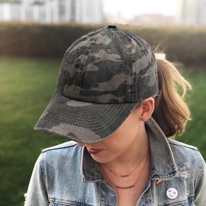 Detail of classic jungle camouflage baseball cap with curved brim for outdoor activities