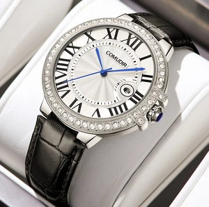 Detailed close-up of a silver rhinestone bezel watch with blue hands and a Roman dial