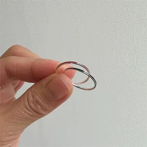 Close-up of minimalist S925 sterling silver thin band rings in silver and rose gold