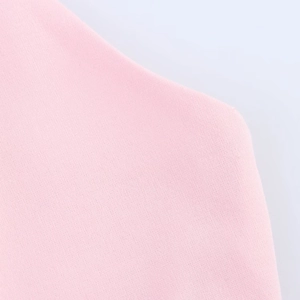 Detailed close-up showing the fine texture and high-quality pink knit fabric of the dress