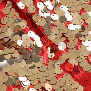 Macro detail of red sequins and invisible zipper closure on the feather evening dress