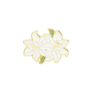 Close-up of lily brooch with white enamel petals, golden edges and green leaves detail
