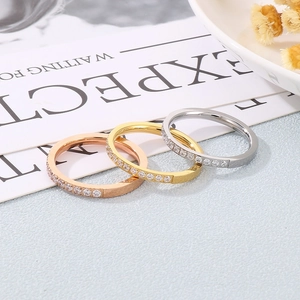 Close-up of rose gold, gold and silver minimalist rings with pave-set zircon crystals