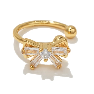 Macro shot of 18k gold plated bowknot ear cuff with baguette cubic zirconia stones