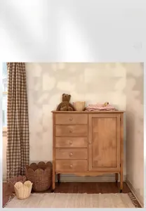 Detail showing the sunflower-shaped rattan wall basket and tabletop storage basket in a room