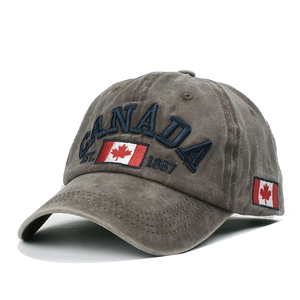 Detailed close-up of blue CANADA embroidery and flag patch on washed cotton baseball cap