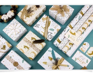 Animal print wrapping paper set with gold foil leopard patterns and matching gift tags