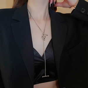 Silver teardrop Y-shaped necklace shown on a model with a stylish black blazer
