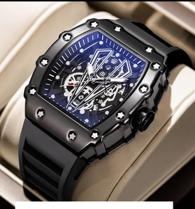Detail of tonneau-shaped men's watch featuring a black skeleton dial and blue accents
