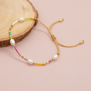 Handmade colorful seed bead bracelet with natural freshwater pearls and adjustable gold cord