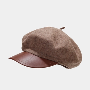 Detailed view of the brown wool beret with premium leather brim and stitching craft