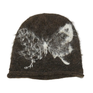Close-up of a brown knit beanie featuring fuzzy white butterfly patterns and rolled edges