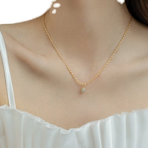 Minimalist 18K gold plated necklace with green aventurine bead on female model neckline