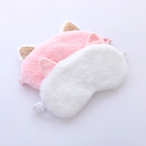 Close-up of soft plush cat ear sleep masks in pink and white with faux fur texture