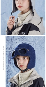 Detail of children's knit aviator hats with warm fleece lining and protective goggles