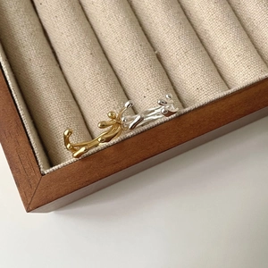 Detailed view of organic liquid-metal style rings in gold and silver finish