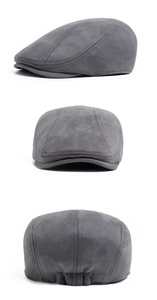 Three-way view of grey faux suede newsboy cap showing seams and elastic back detail