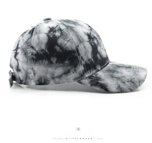 Side profile of a retro black and white tie-dye baseball cap with stitched brim